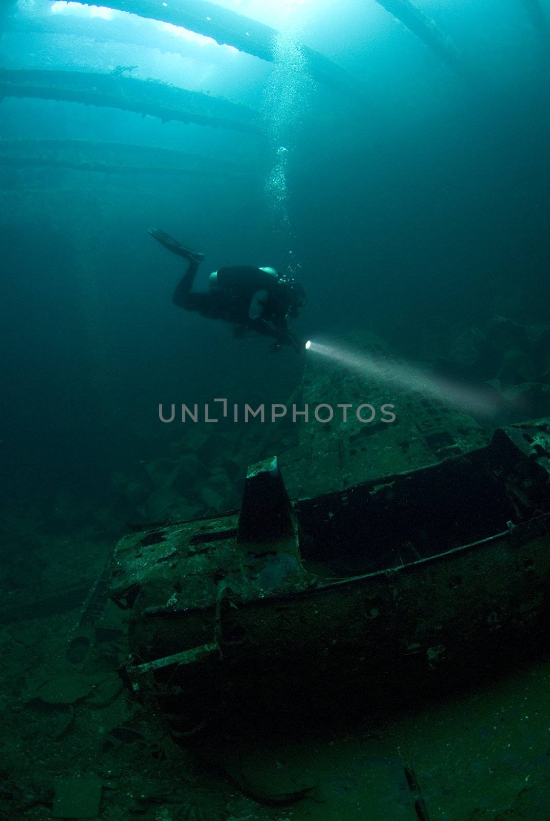 A diver inspects the fuselage of a Japanese Zero fighter plane, found in the hold of the Fujikawa Maru, an aircraft transport sunk during Operation Hailstone, Febuary 1944, in Truk (Chuuk) Lagoon, Micronesia during World War II