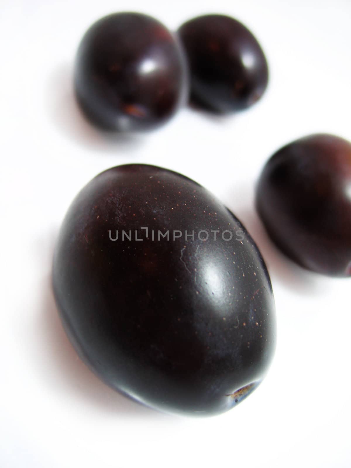 some plums isolated on white
