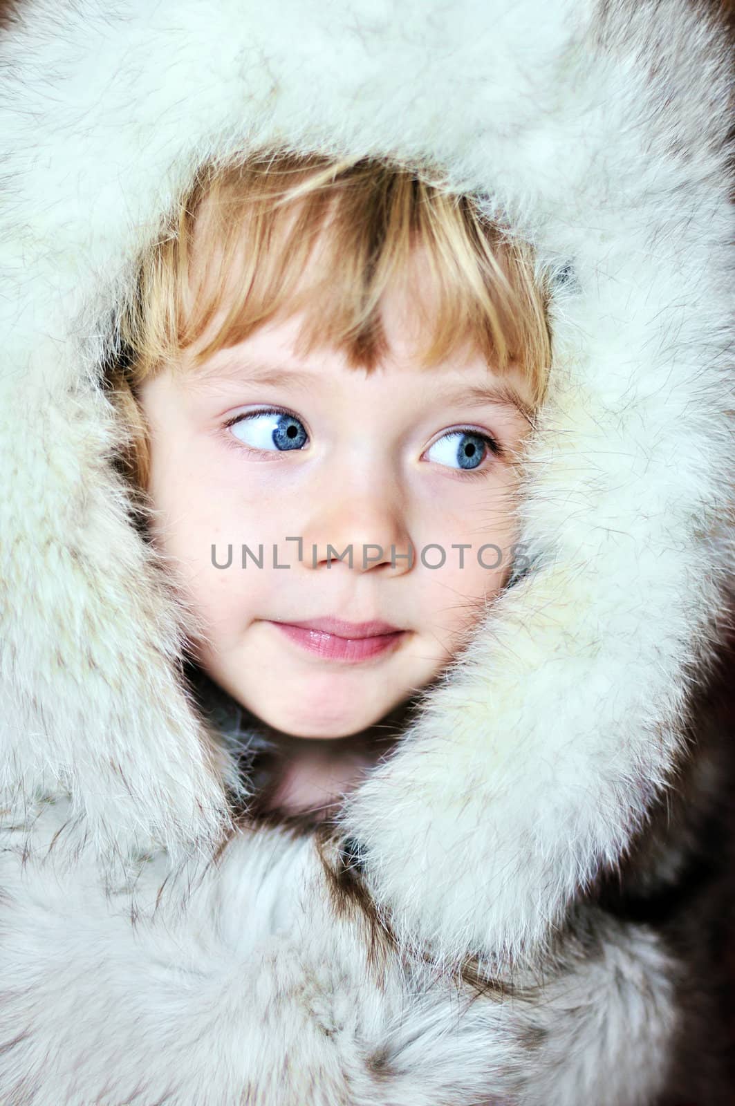 little lovely  girl wearing fur hat 