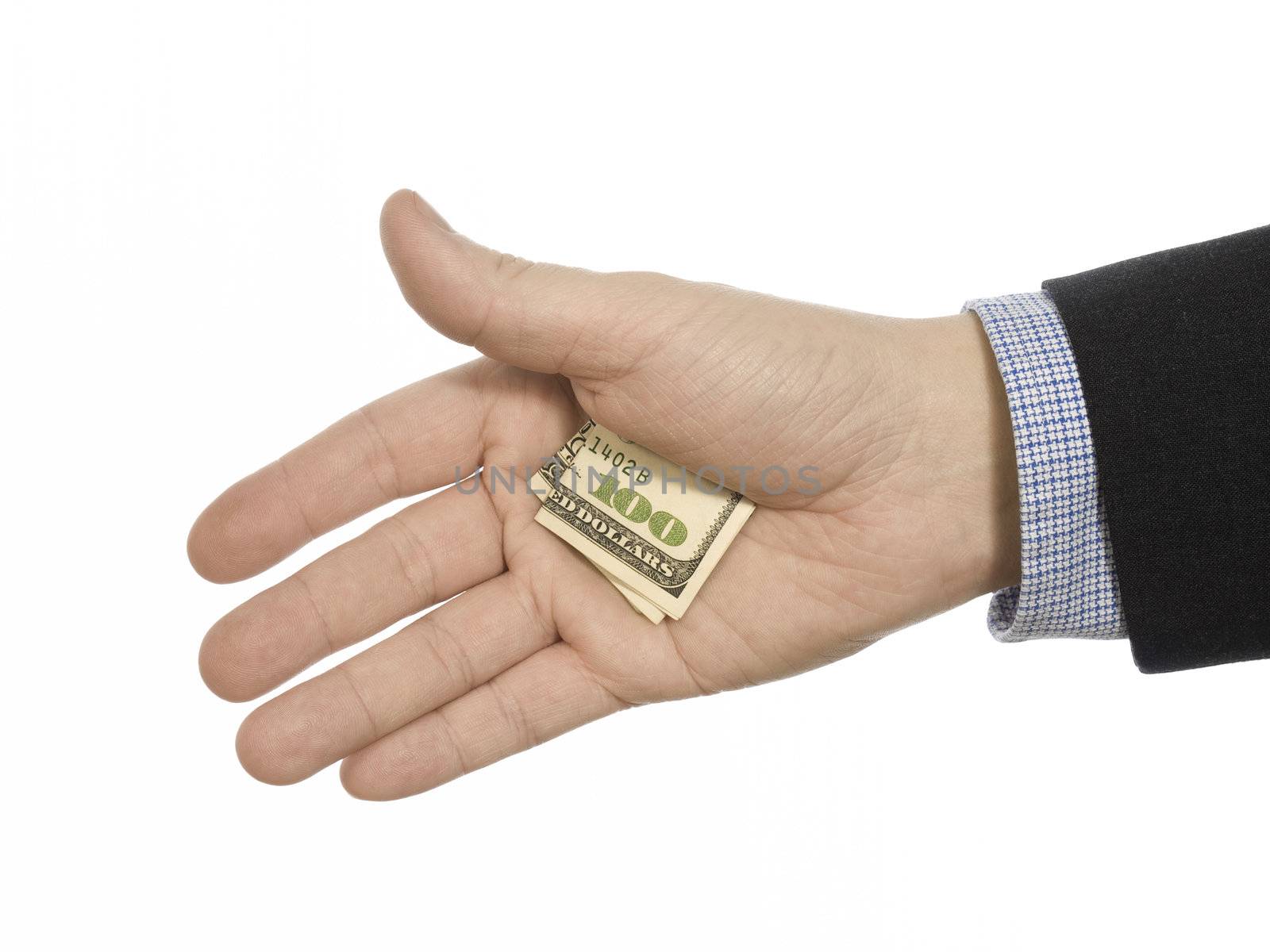 A man's hand hiding a hundred dollars tip.