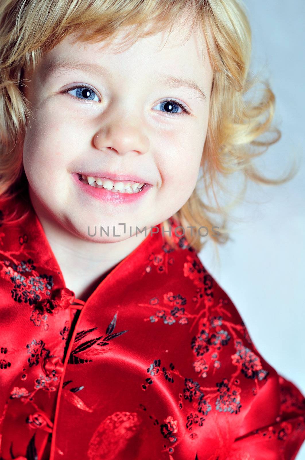 cheerful little girl wearing red dress