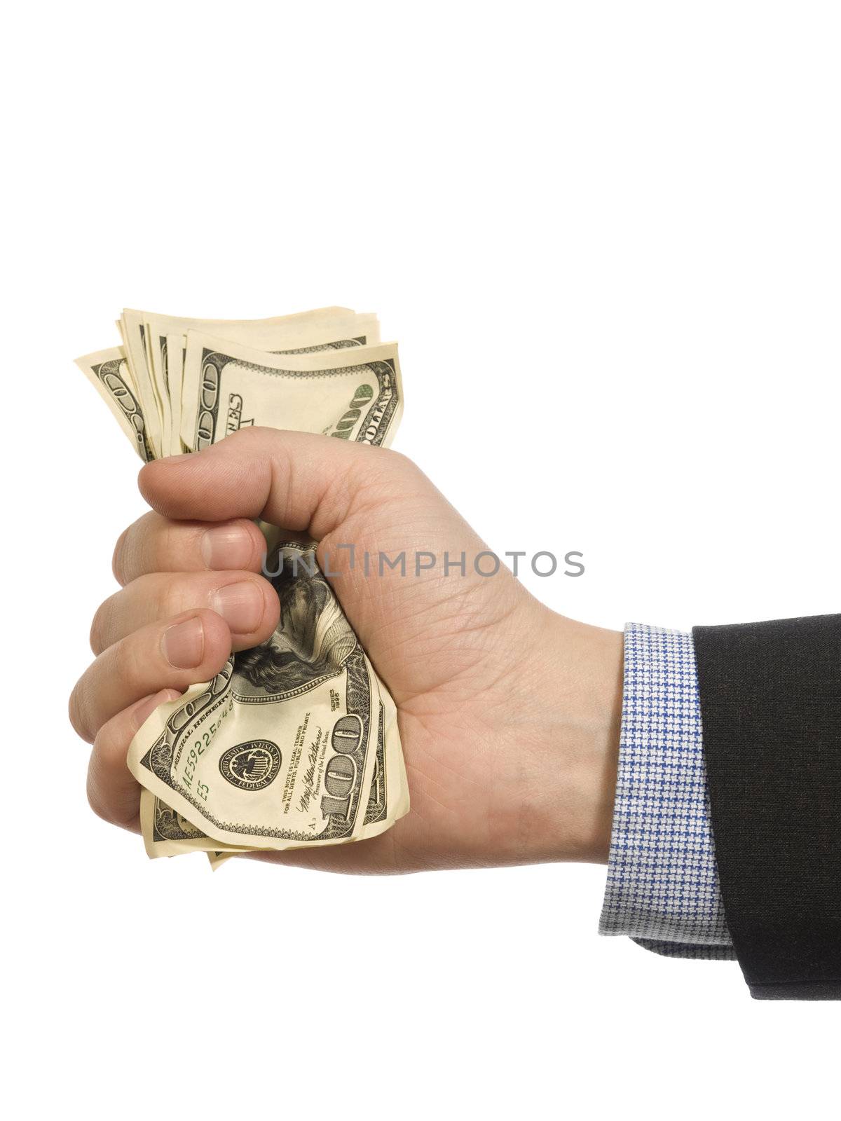 A man's hand holding a handful of dollars.