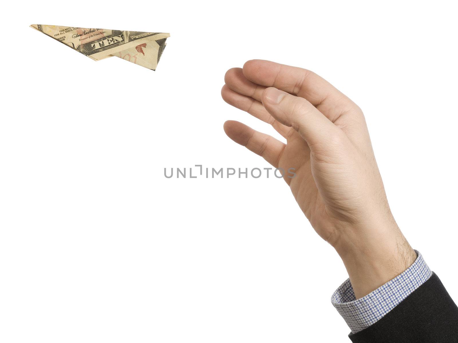 A man's hand throwing a paper plane made of a ten dollar bill.