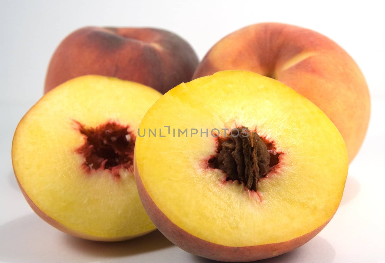 Peach with seed foreground. Shalow depth of field. by serpl