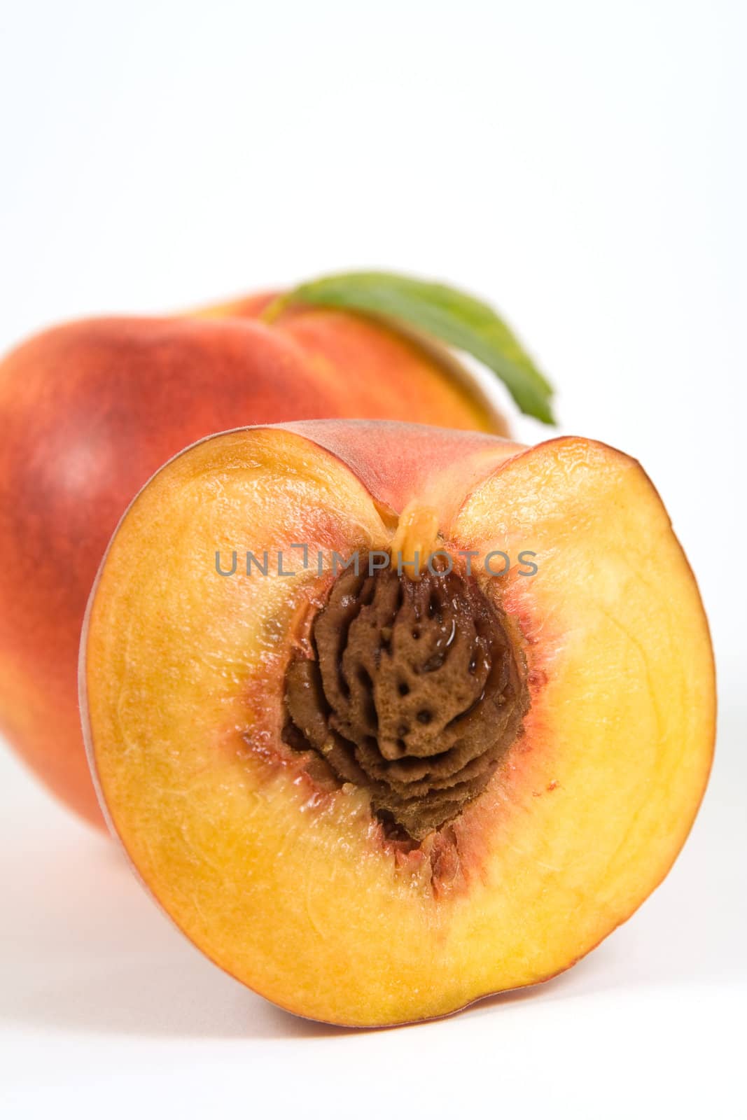 Closeup image devided in half juicy peach