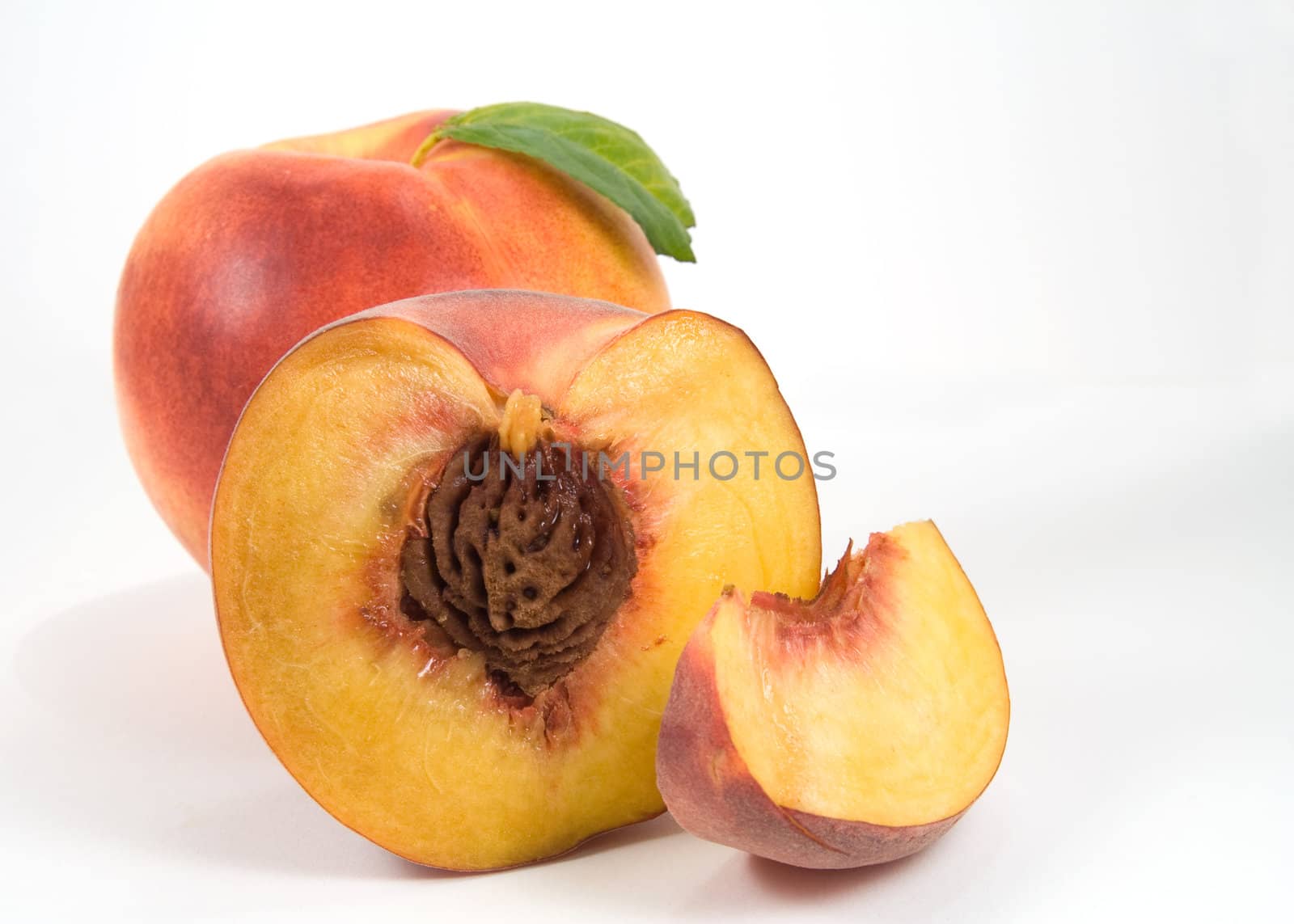Nectarine, half of peach and slice on white background