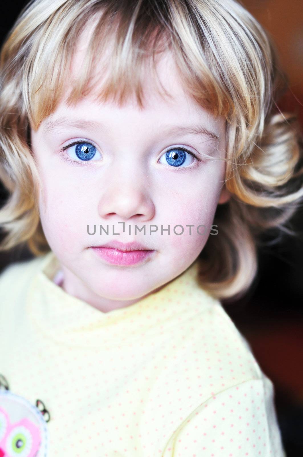 little blue-eyed pretty girl looking at the camera