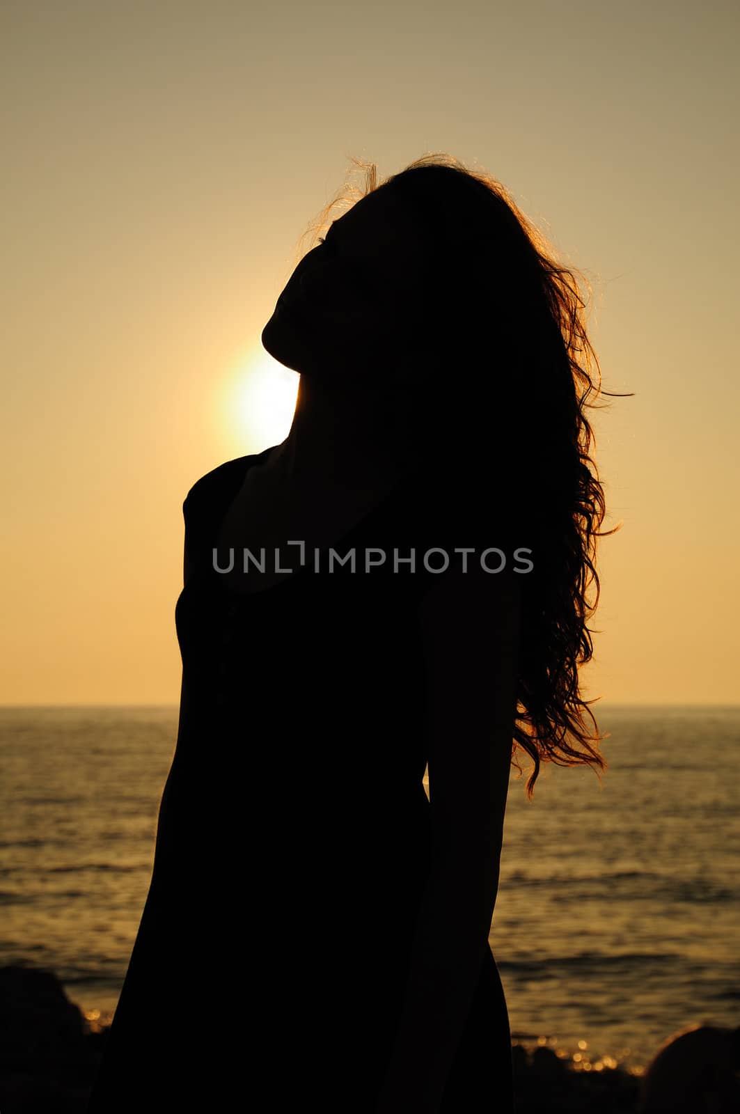 silhouette of sunset girl at the beach