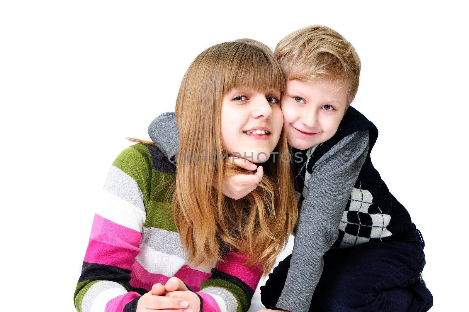 happy brother and sister in studio over the white
