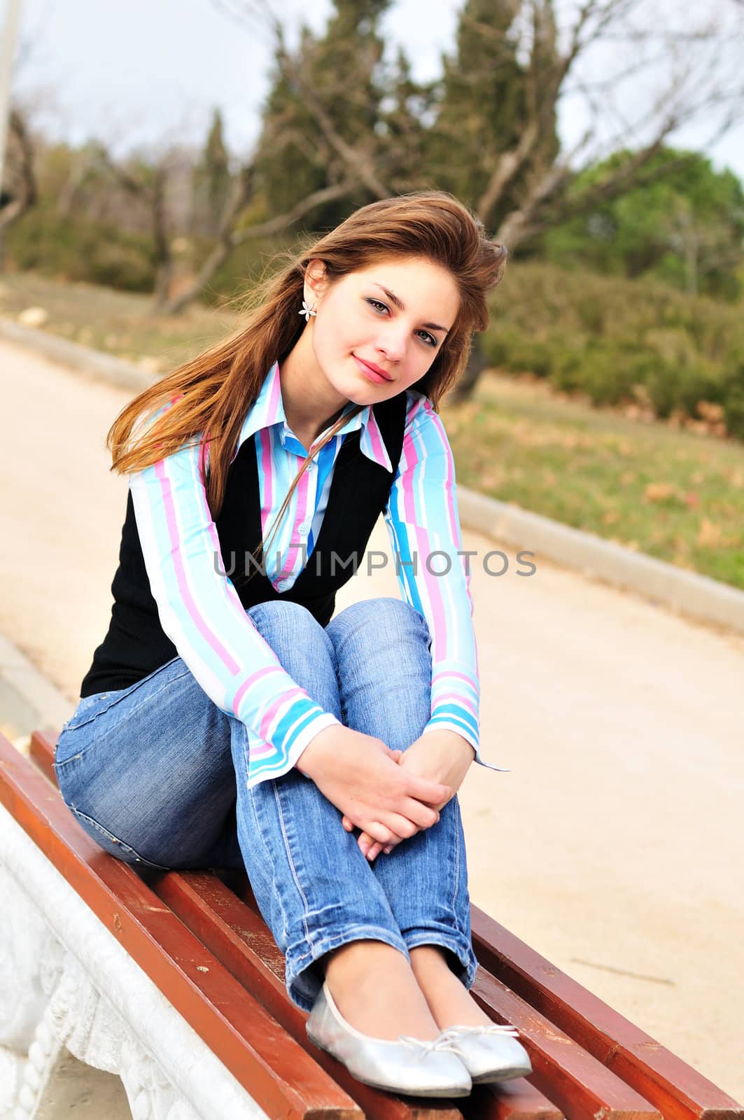 teen girl resting in the park on the bench