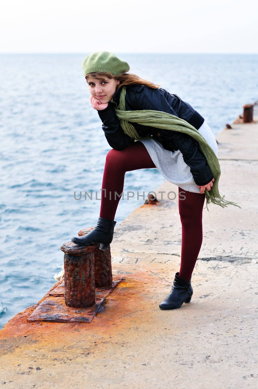 romantic teen girl standing on the  dock