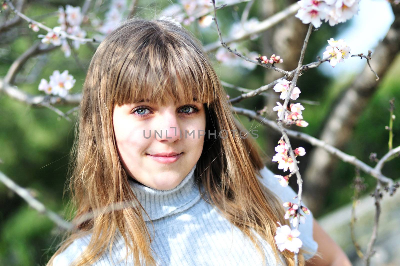 teen girl in spring time near the first blossoms