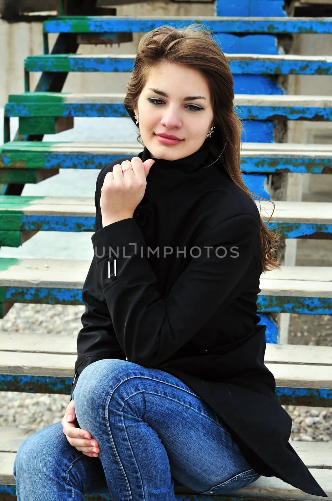 Pretty teen girl sitting on the stairs