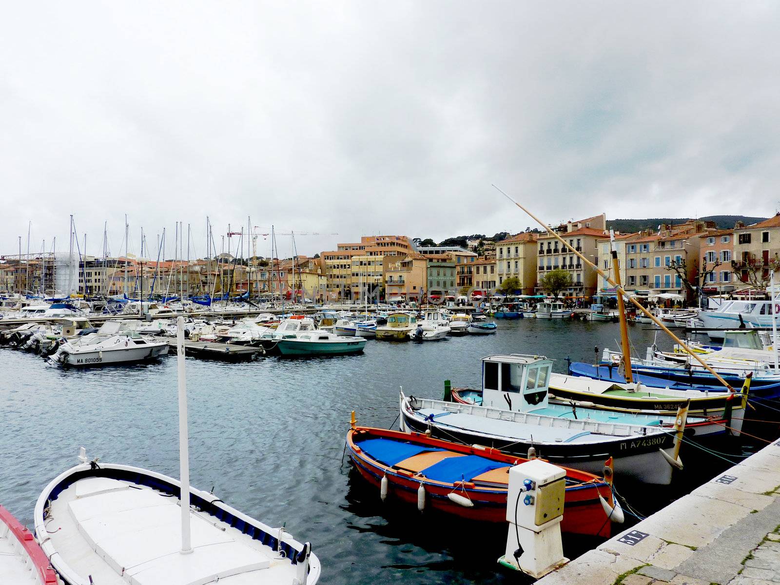 Port of La Ciotat, France, with boats and buildings by cloudy weather