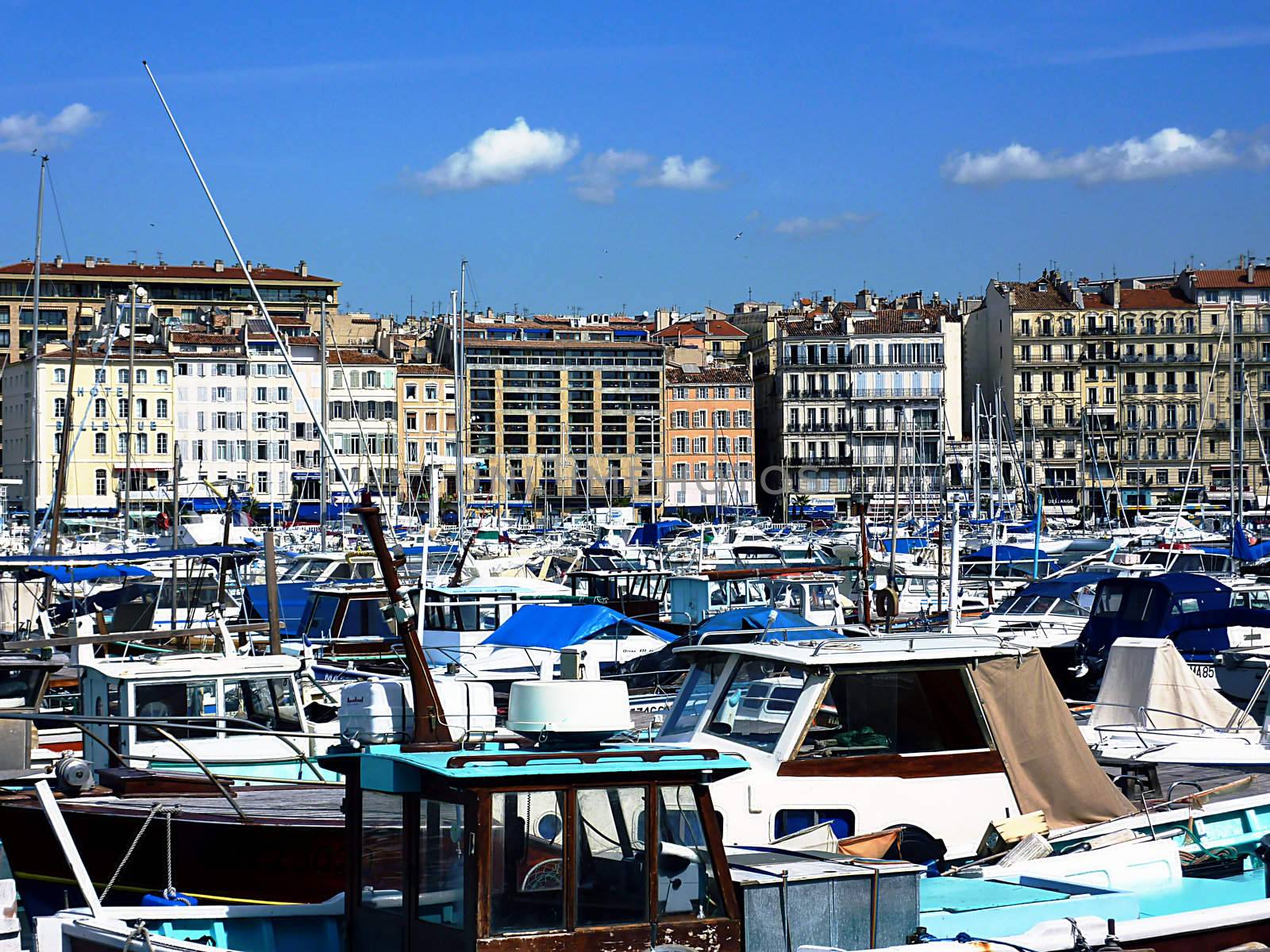 Many boats and buildings in the old port of Marseilles, France, by beautiful weather