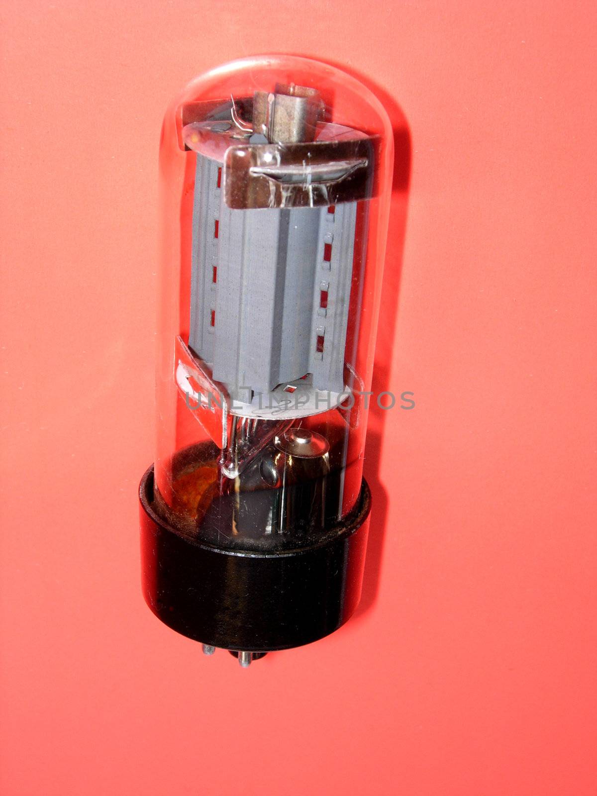 Electronic tube on a red background