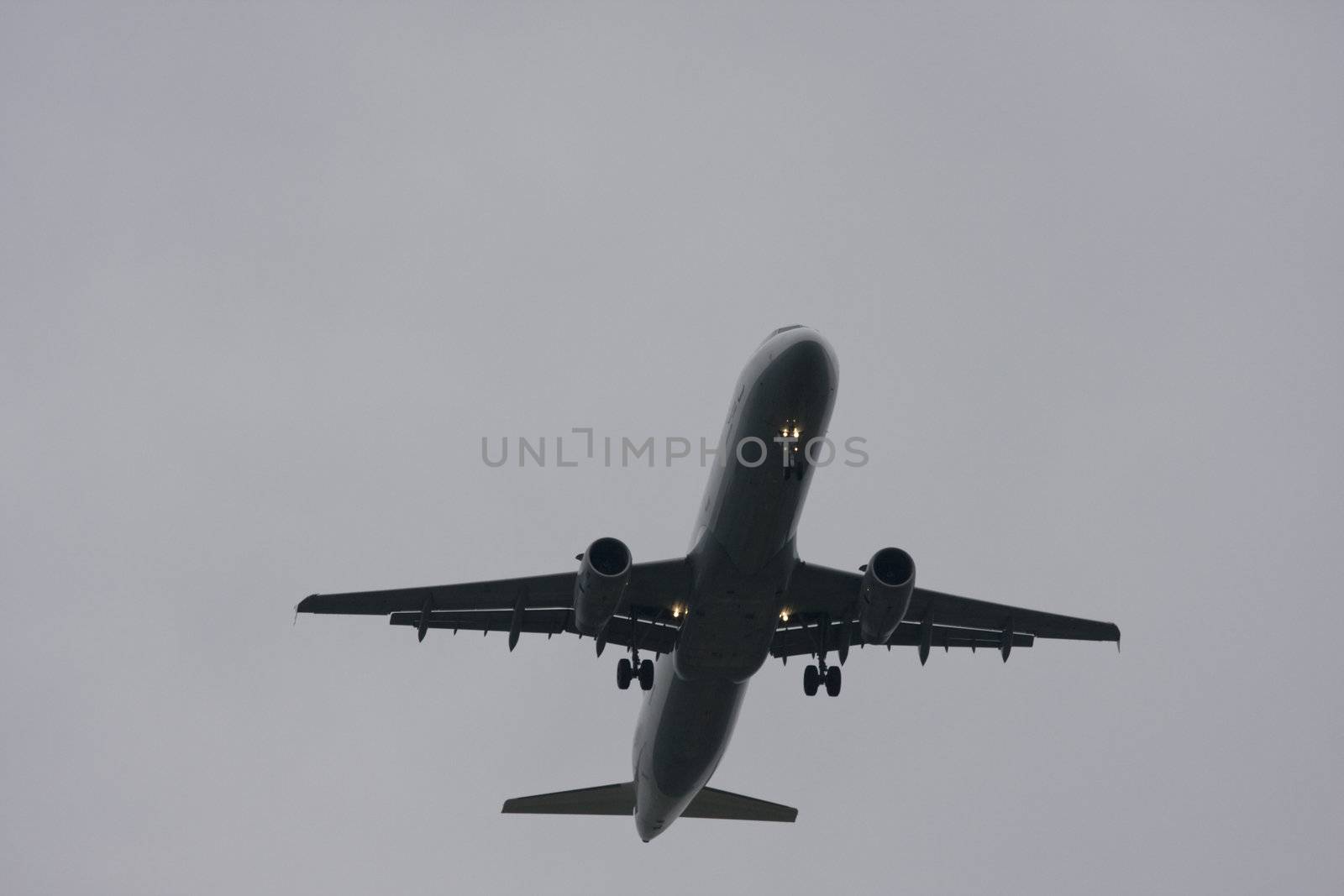 plane landing on a grey day by bernjuer