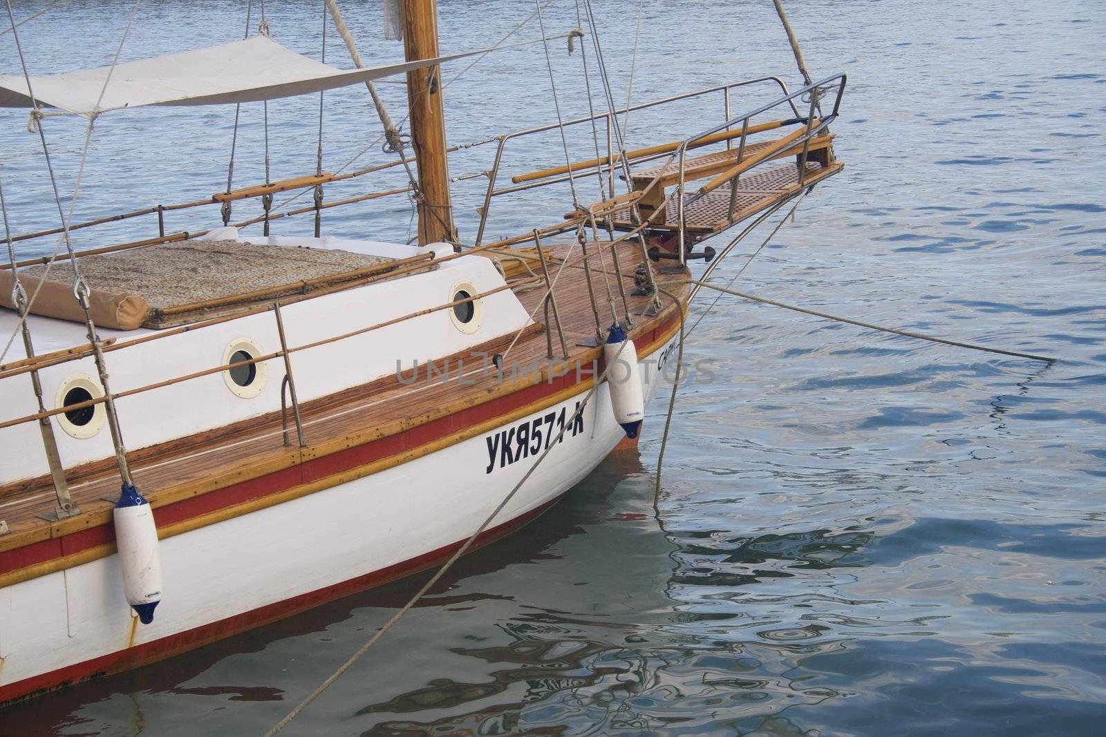 Close-up of a wooden sailboat docked in a harbor
