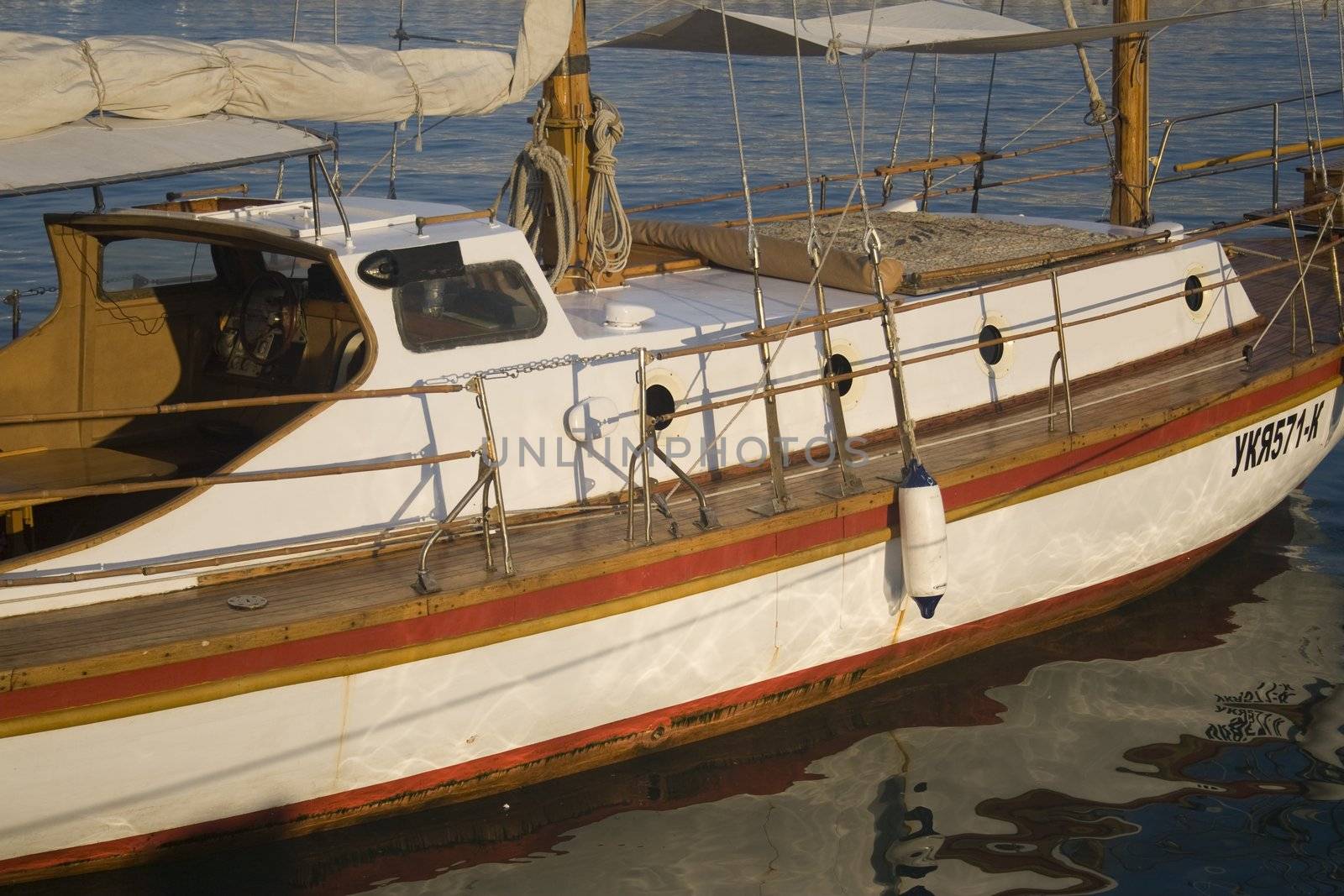 Close-up of a wooden sailboat docked in a harbor
