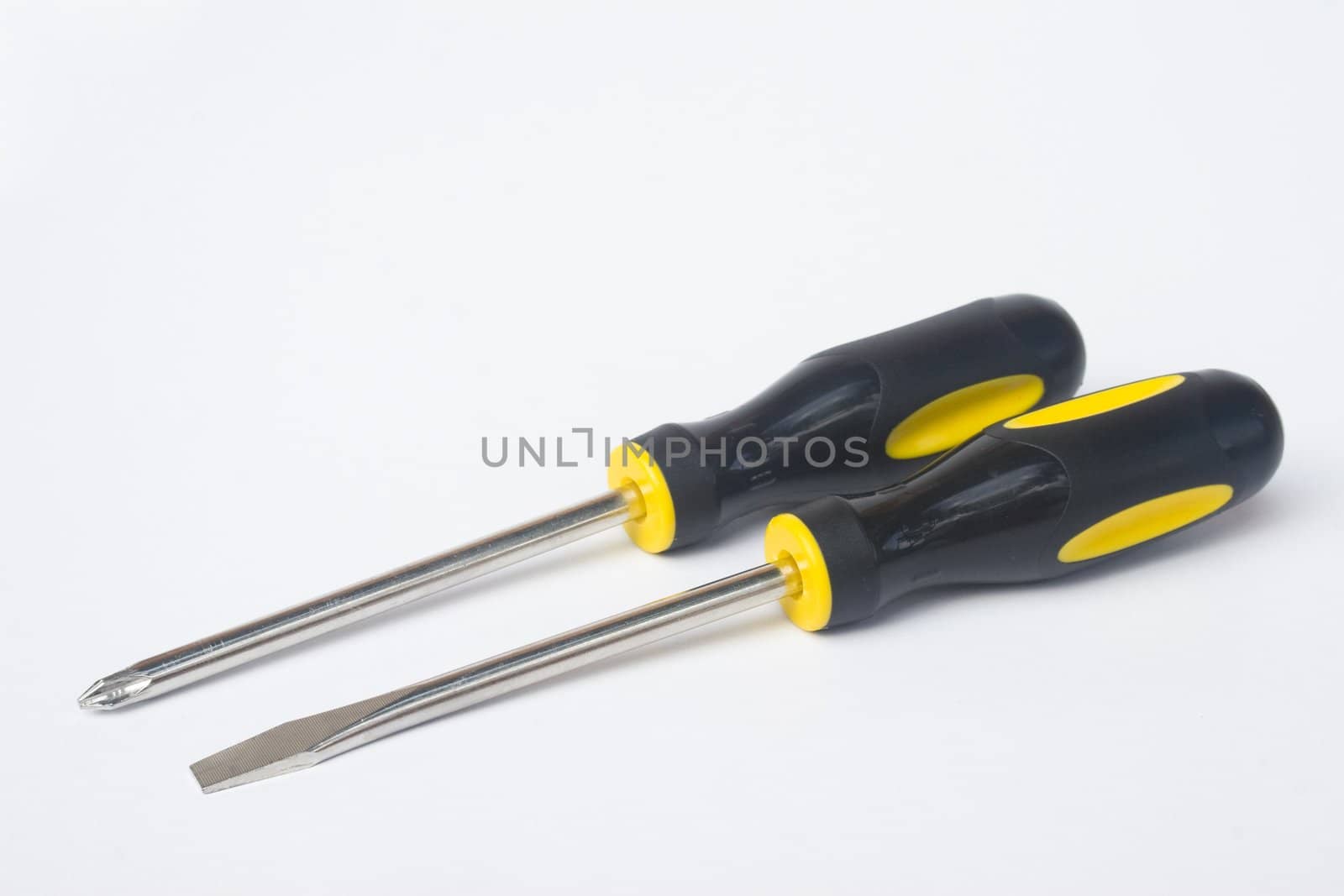 Two yellow and black manual screwdrivers isolated on white background