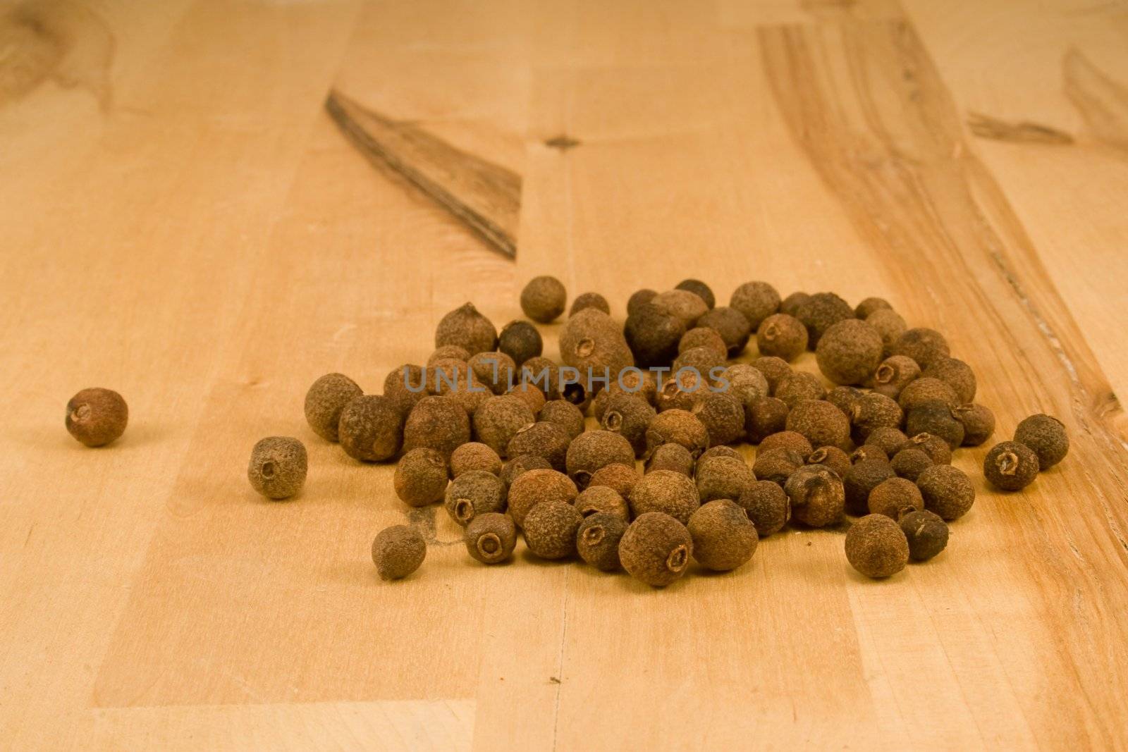 Allspice fruits on wood