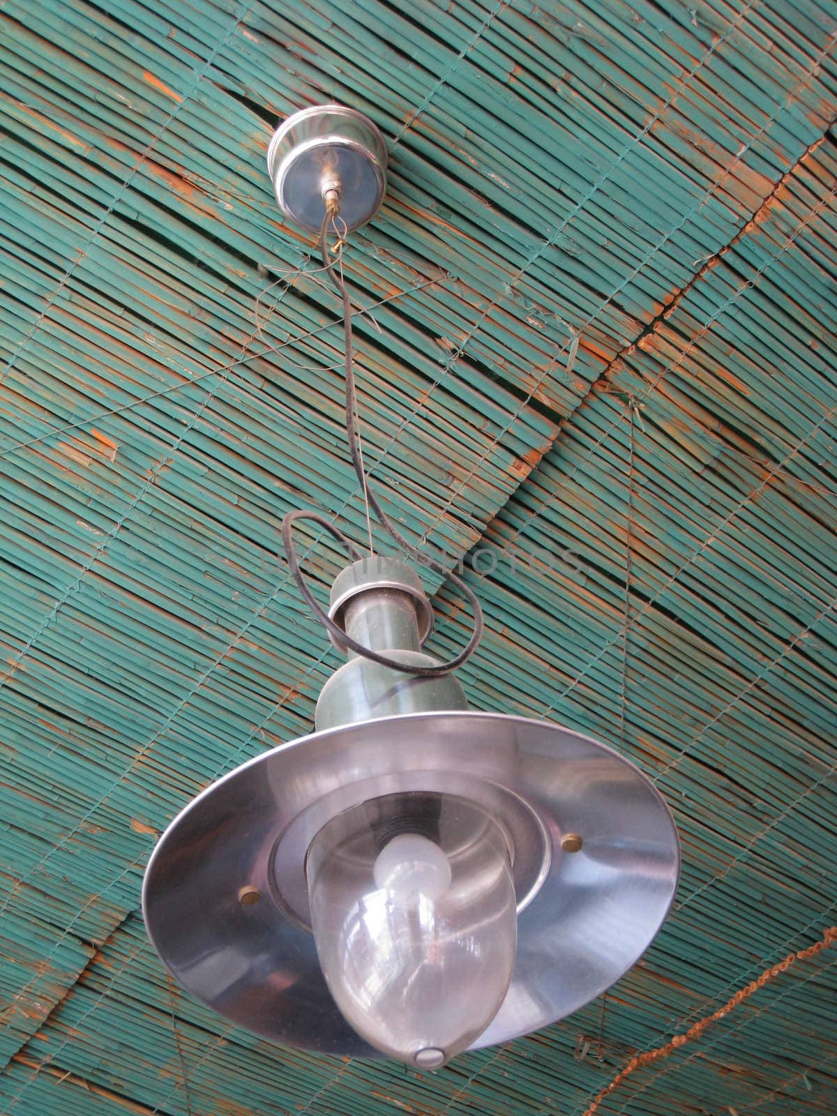 Close-up of a ceiling made of blue reed matt and old fishing lanterns