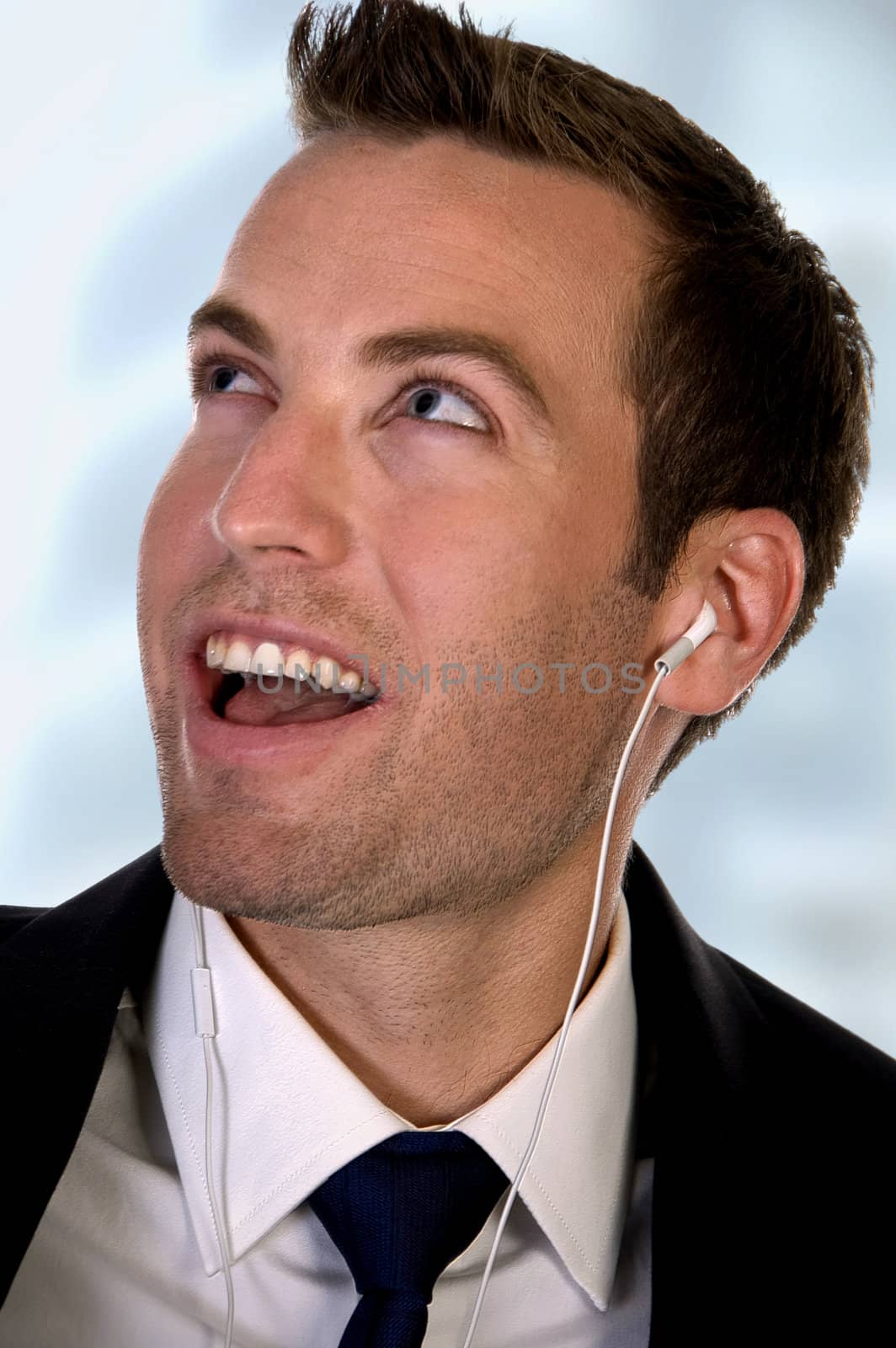 portrait of businessman listening music on an isolated white background