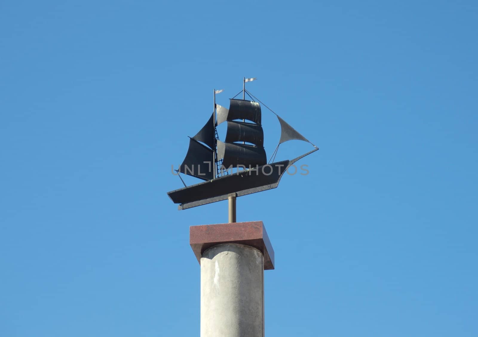 Sculpture of the ship on a background of the dark blue sky