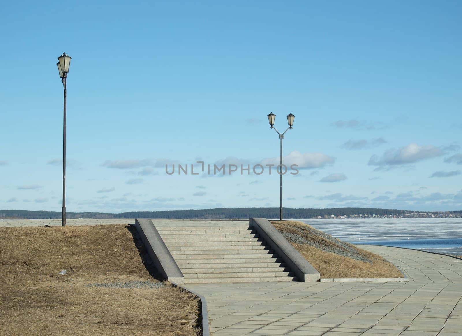 Two lanterns and ladder on quay of Petrozavodsk in the spring, Russia