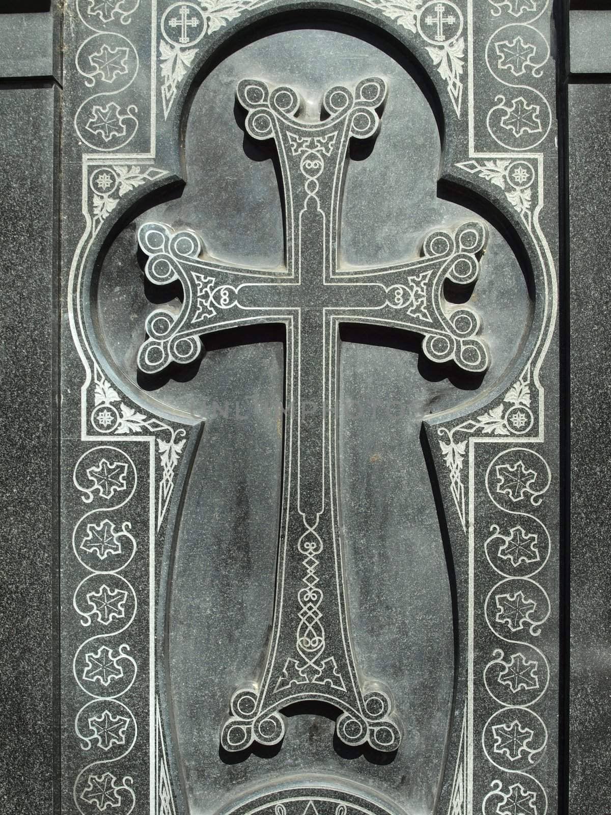 Cross on a black granite wall   