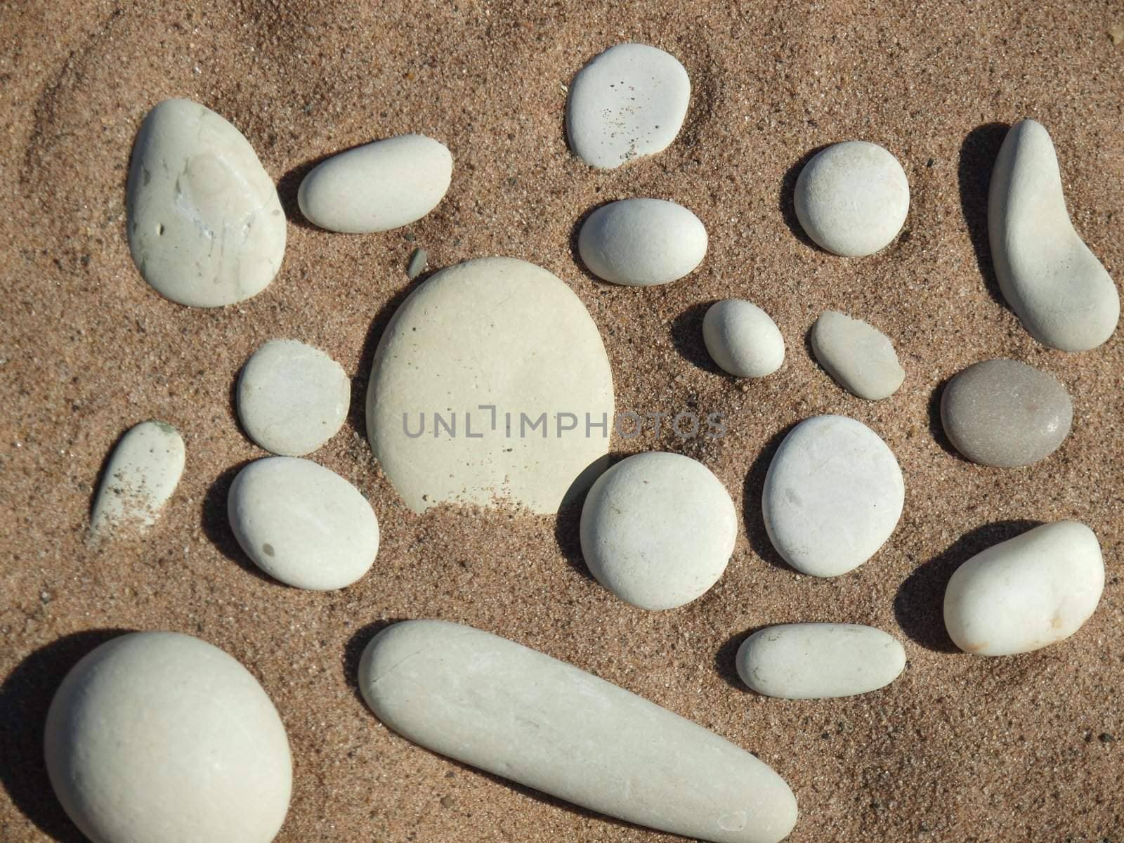 White pebble on sand on coast of lake      