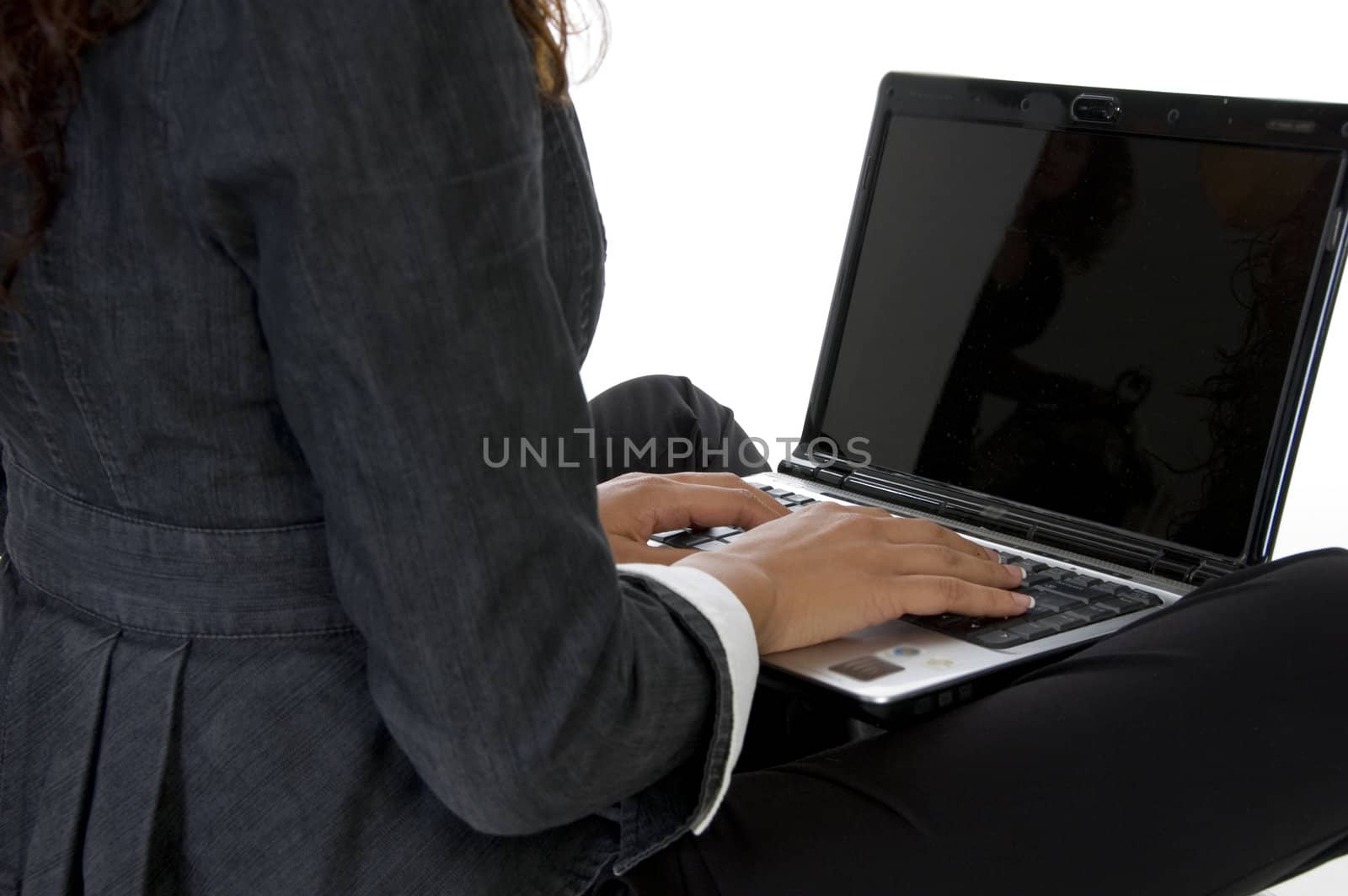 fingers on keyboard of laptop