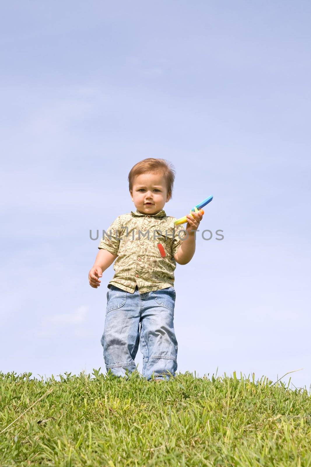 Little boy holding toy cellphone