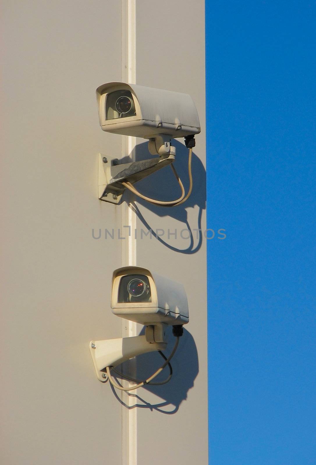 Two security cameras mounted on wall