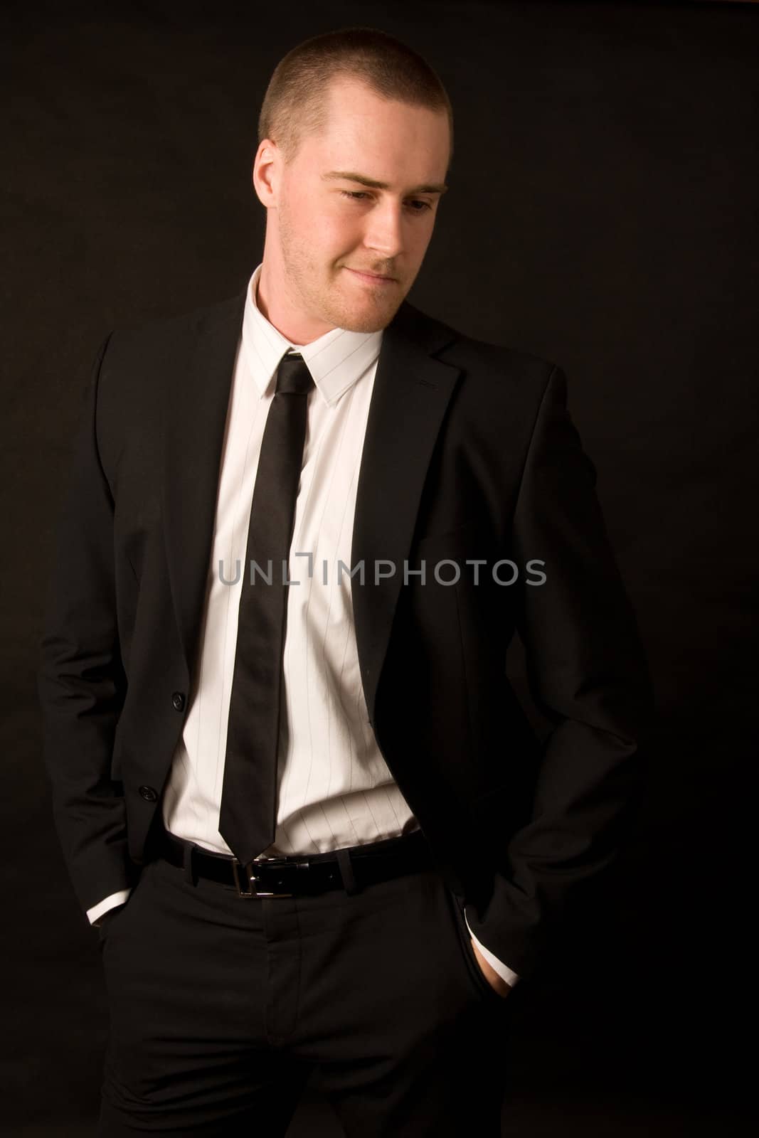 Portrait of a young businessman on dark background