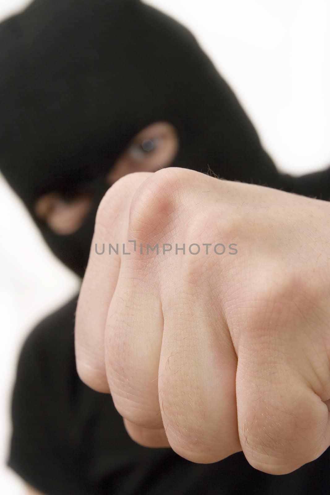 evil criminal wearing military mask and throwing the fist