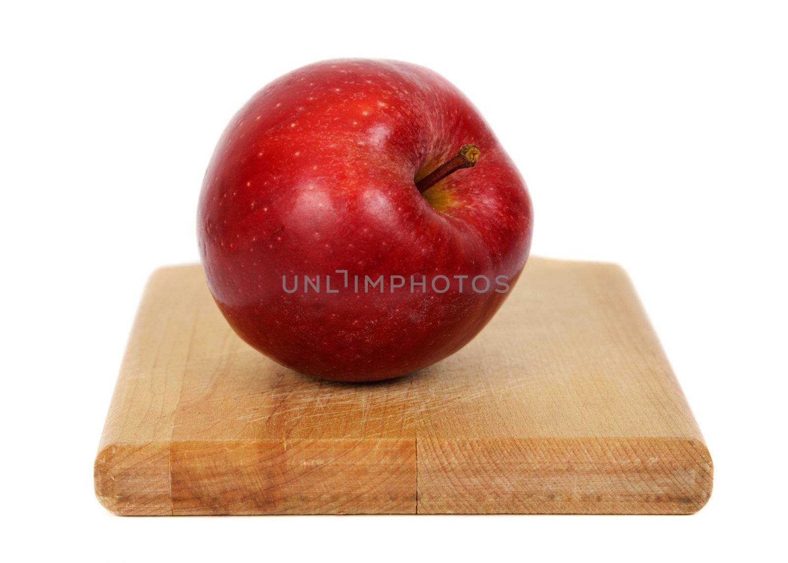 red apple on wood cutting plank