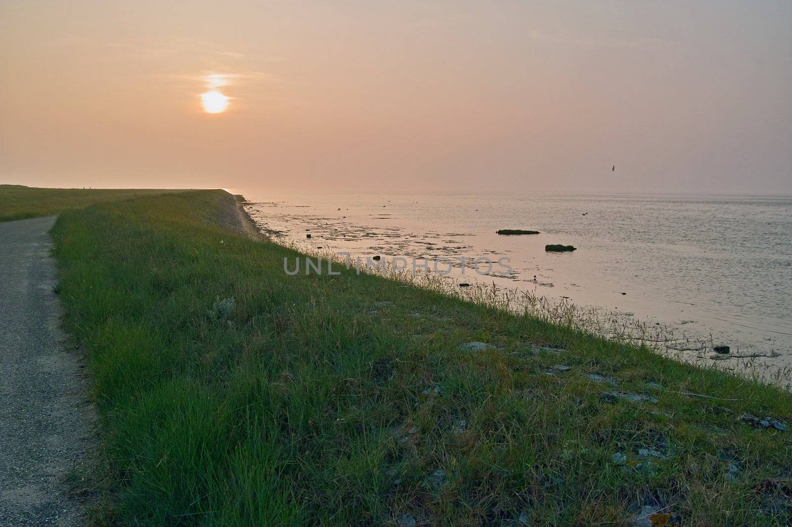 The sun sets at the coast of Wieringen, a former island in the north-west of the Netherlands