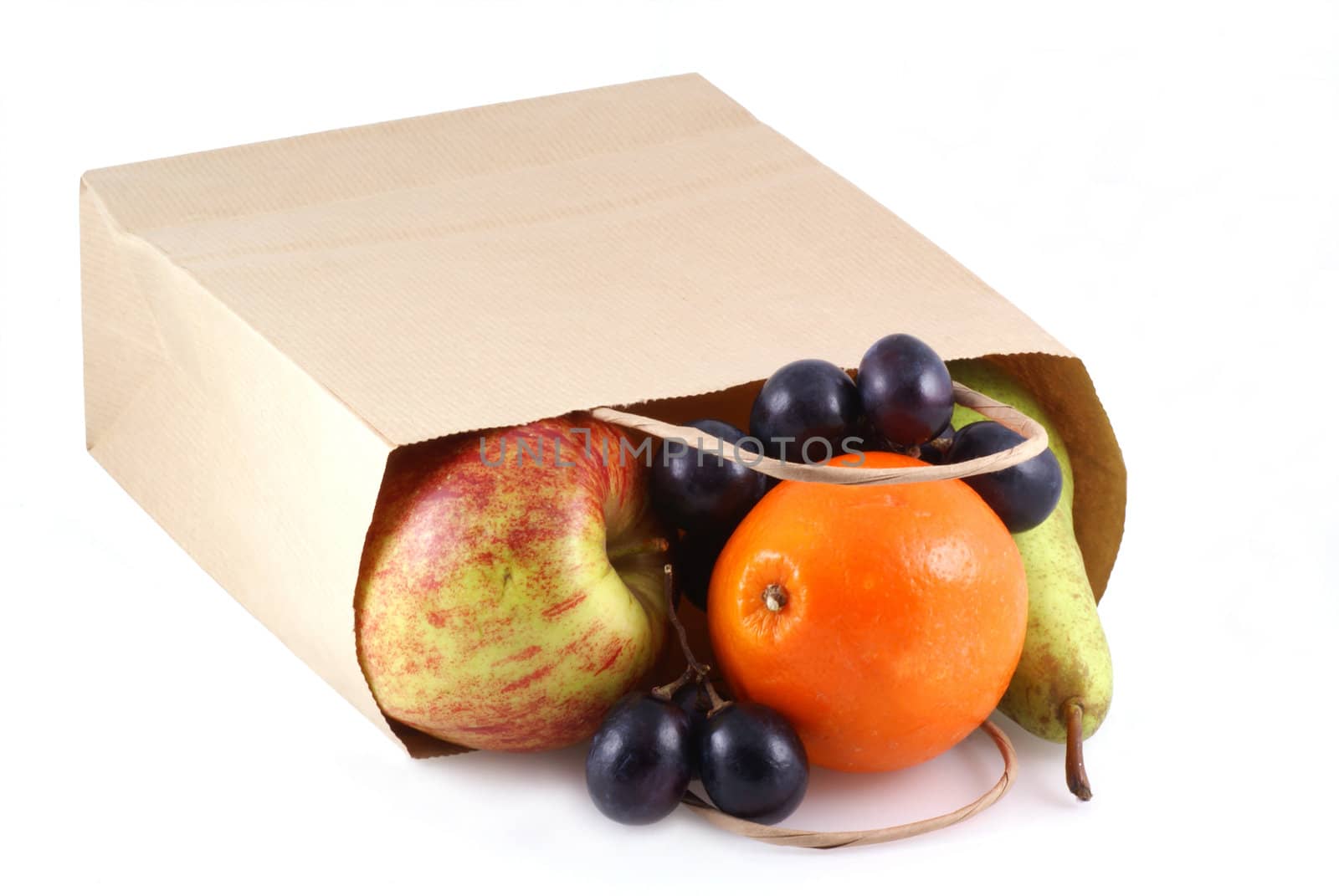 Different kinds of fruit in a paper bag on a white background.