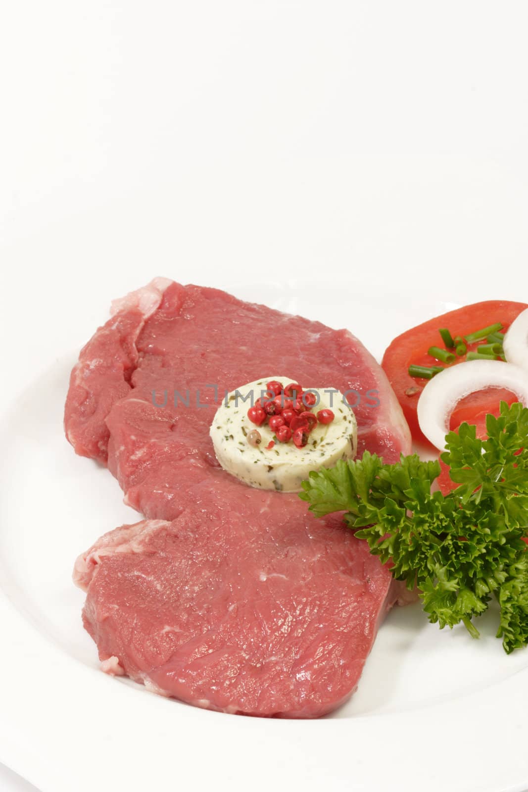 Raw roast beef with garnish on bright background