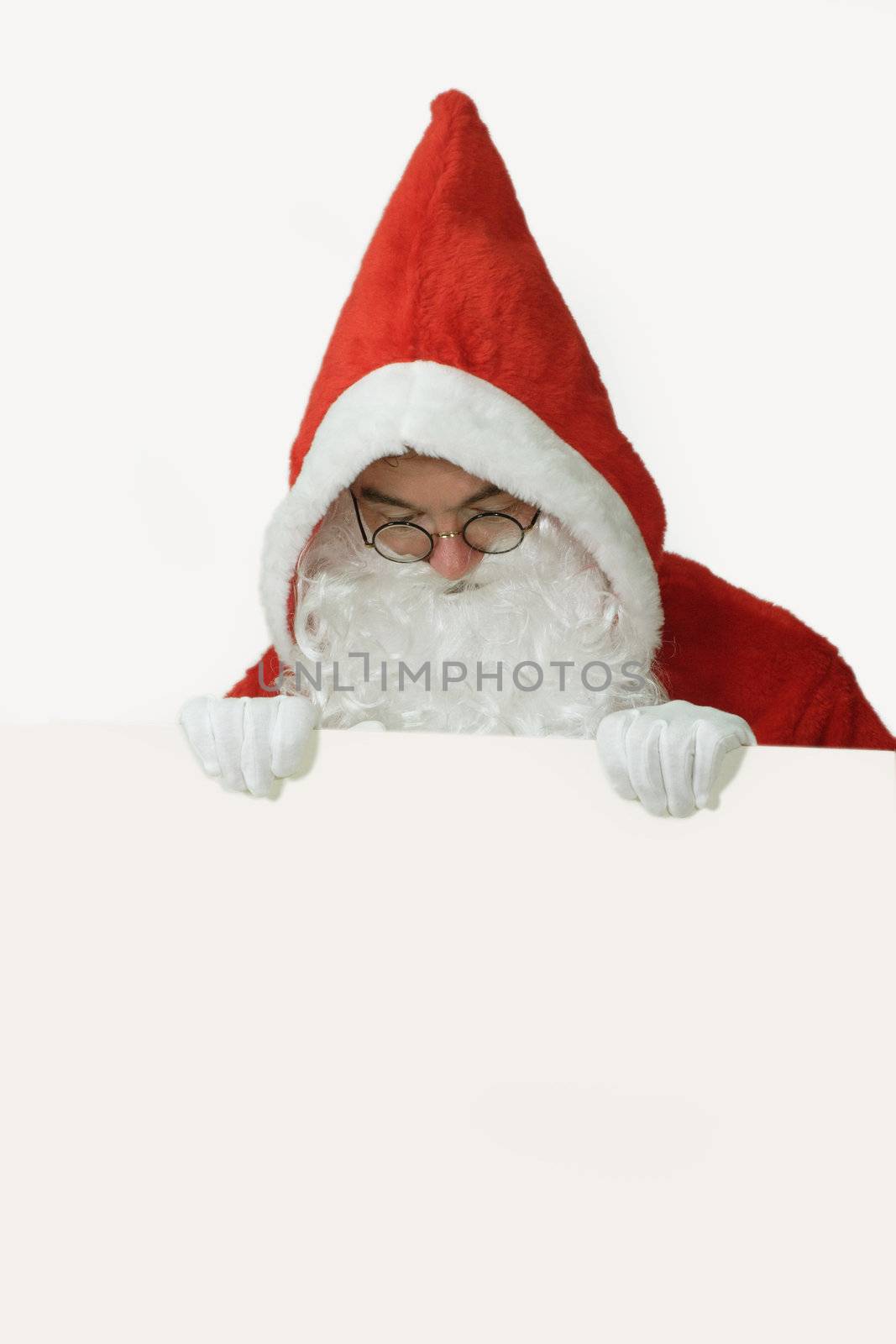 Male caucasian model of santa claus holding a white board - isolated on white background