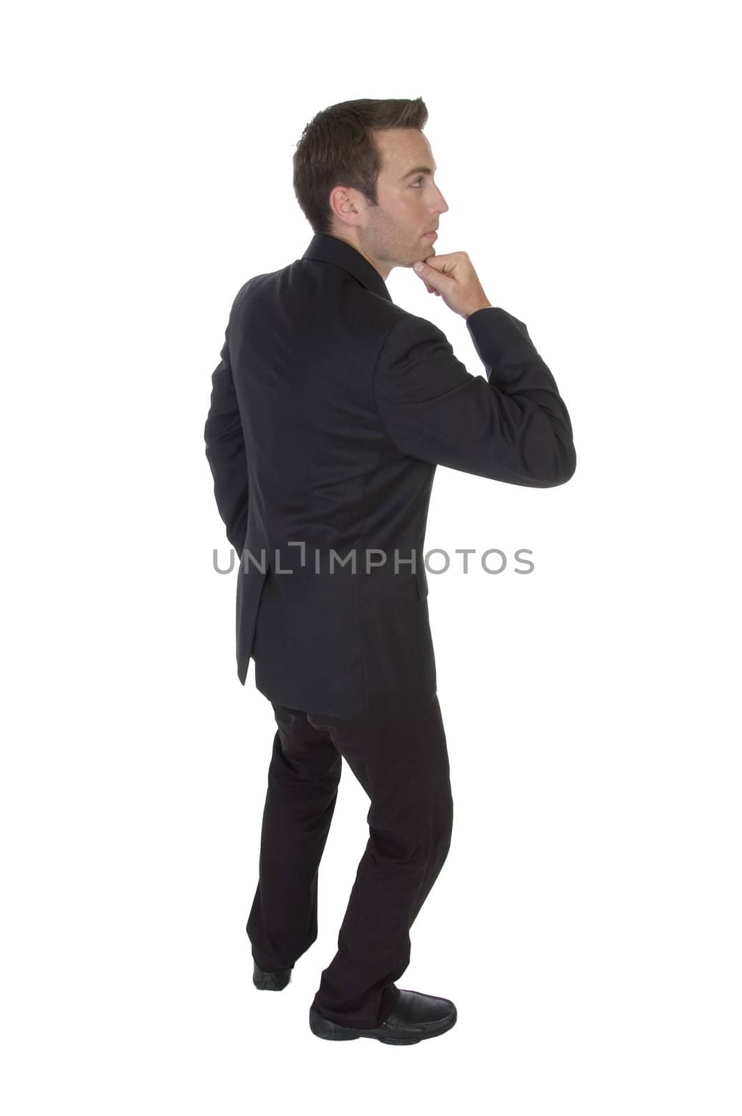 businessman with chin on hand by imagerymajestic