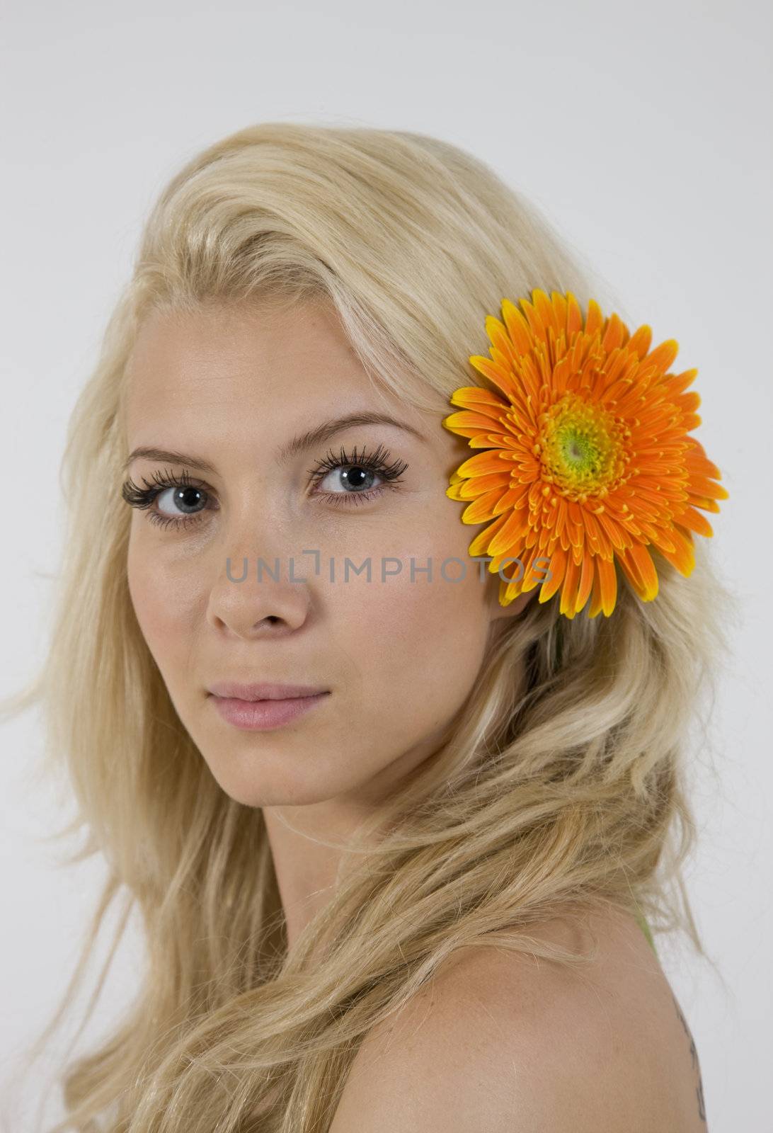 close up of young woman with flower isolated on white background