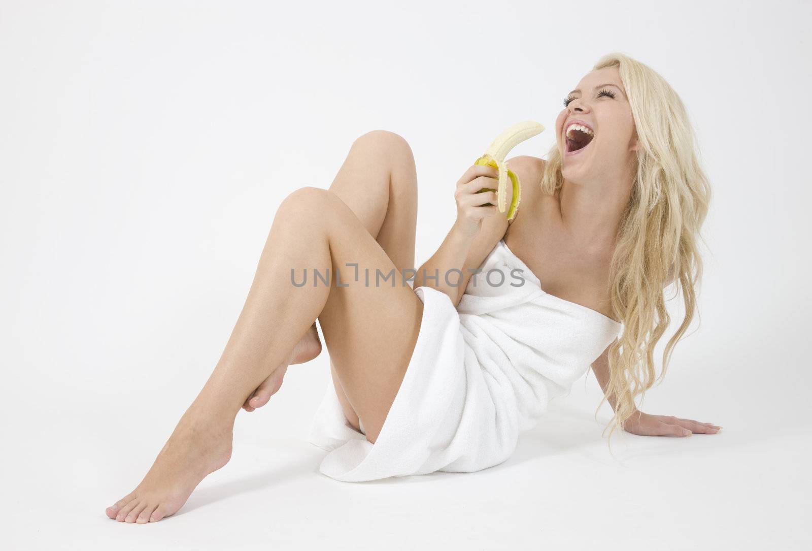 nice blonde woman holding banana on white background
