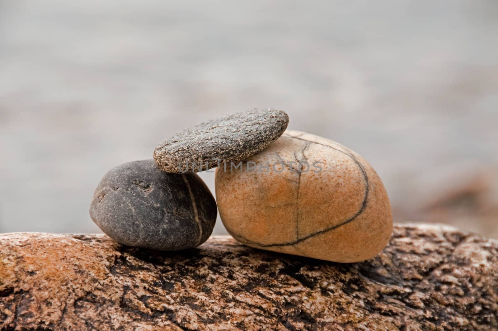 Three pebbles stack on a rock