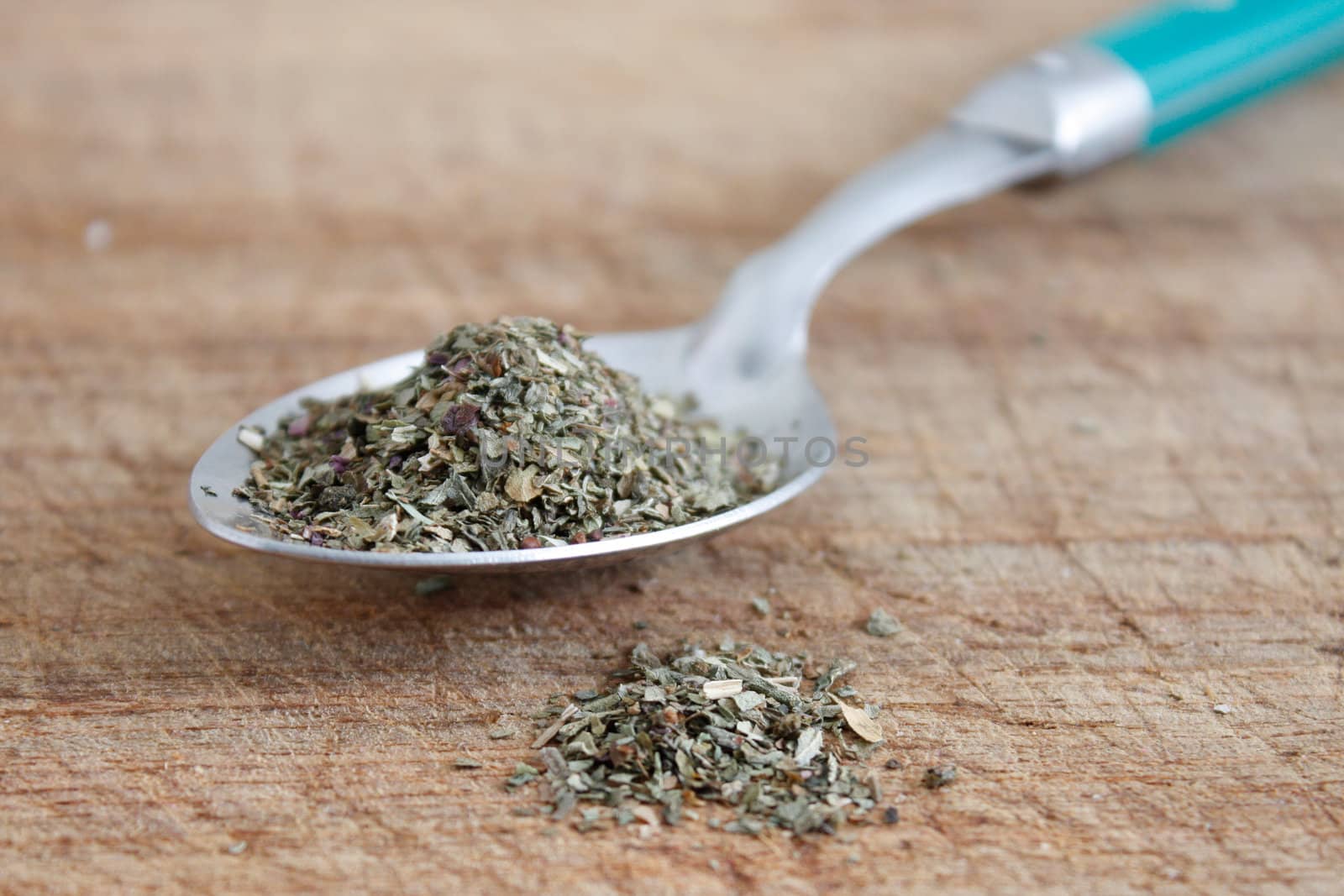 Dried basil on a spoon