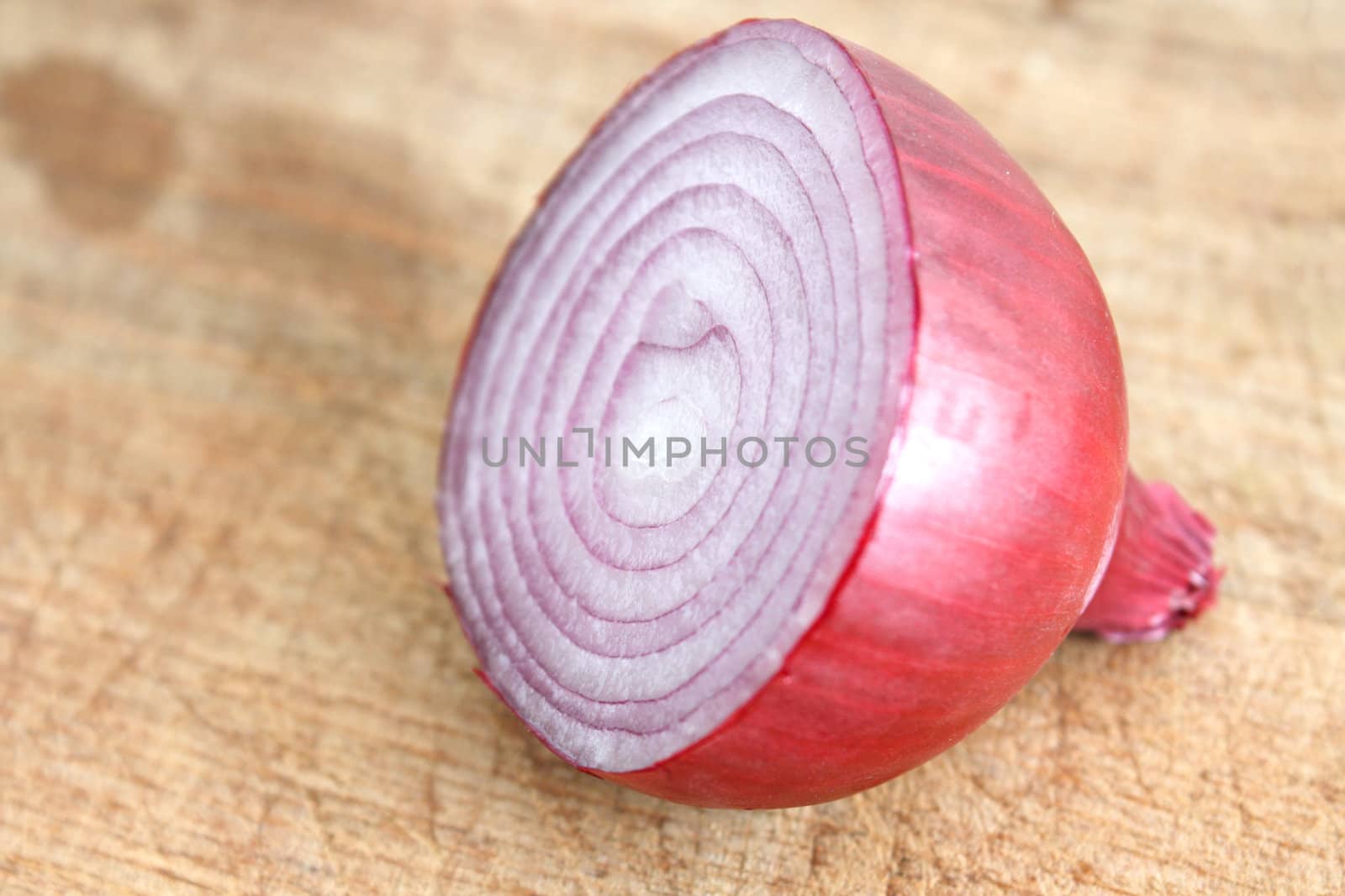 A sliced red onion on a wooden background