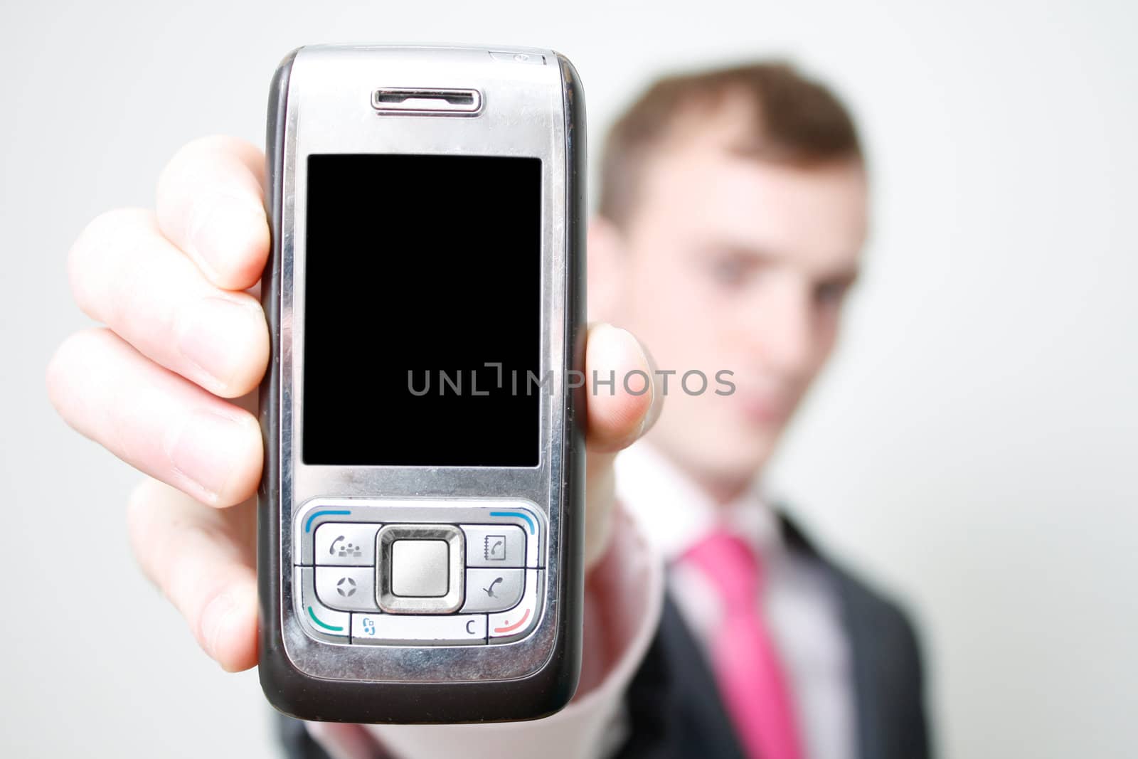 A business man holding a phone