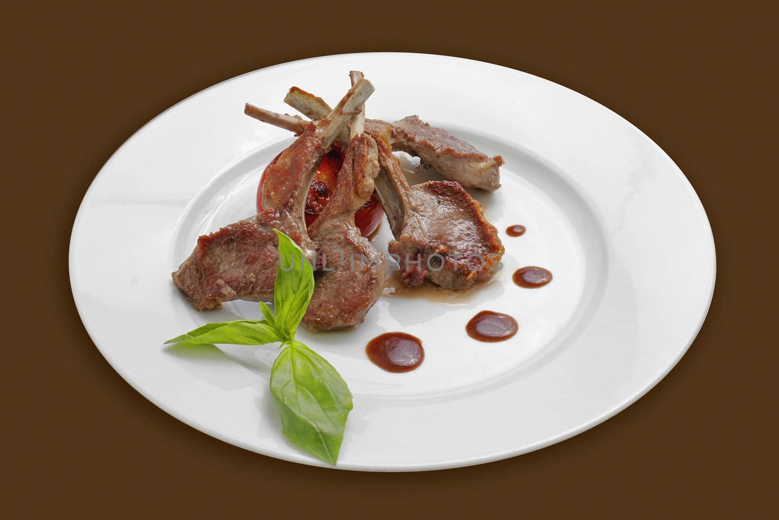 Roasted rack of lamb with a top of basil.