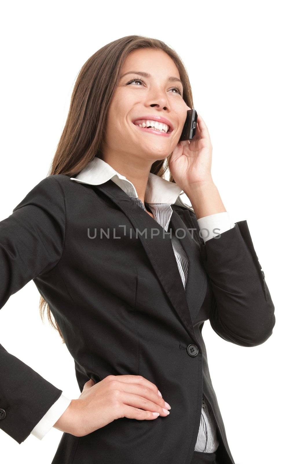 Businesswoman on mobile phone. Beautiful young multiracial Chinese Asian / caucasian woman talking on her cellphone. Isolated on white background.